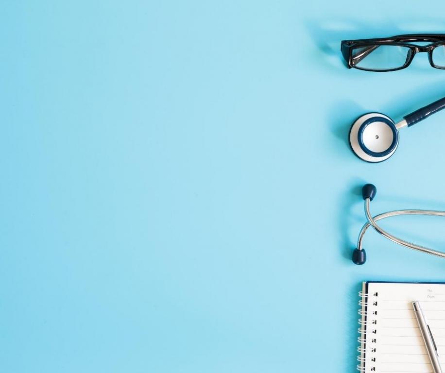 Blue screen with glasses, stethoscope and notepad 